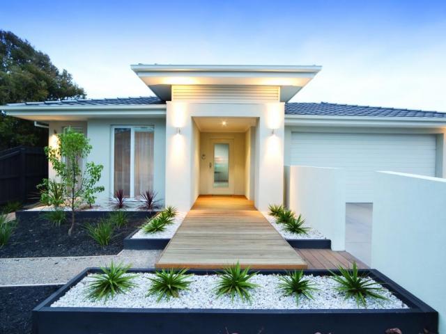 Facade and entry to a contemporary white rendered home in Australia.