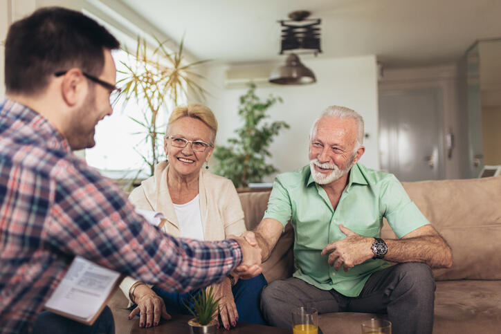 Positive aged couple consulting with insurance agent