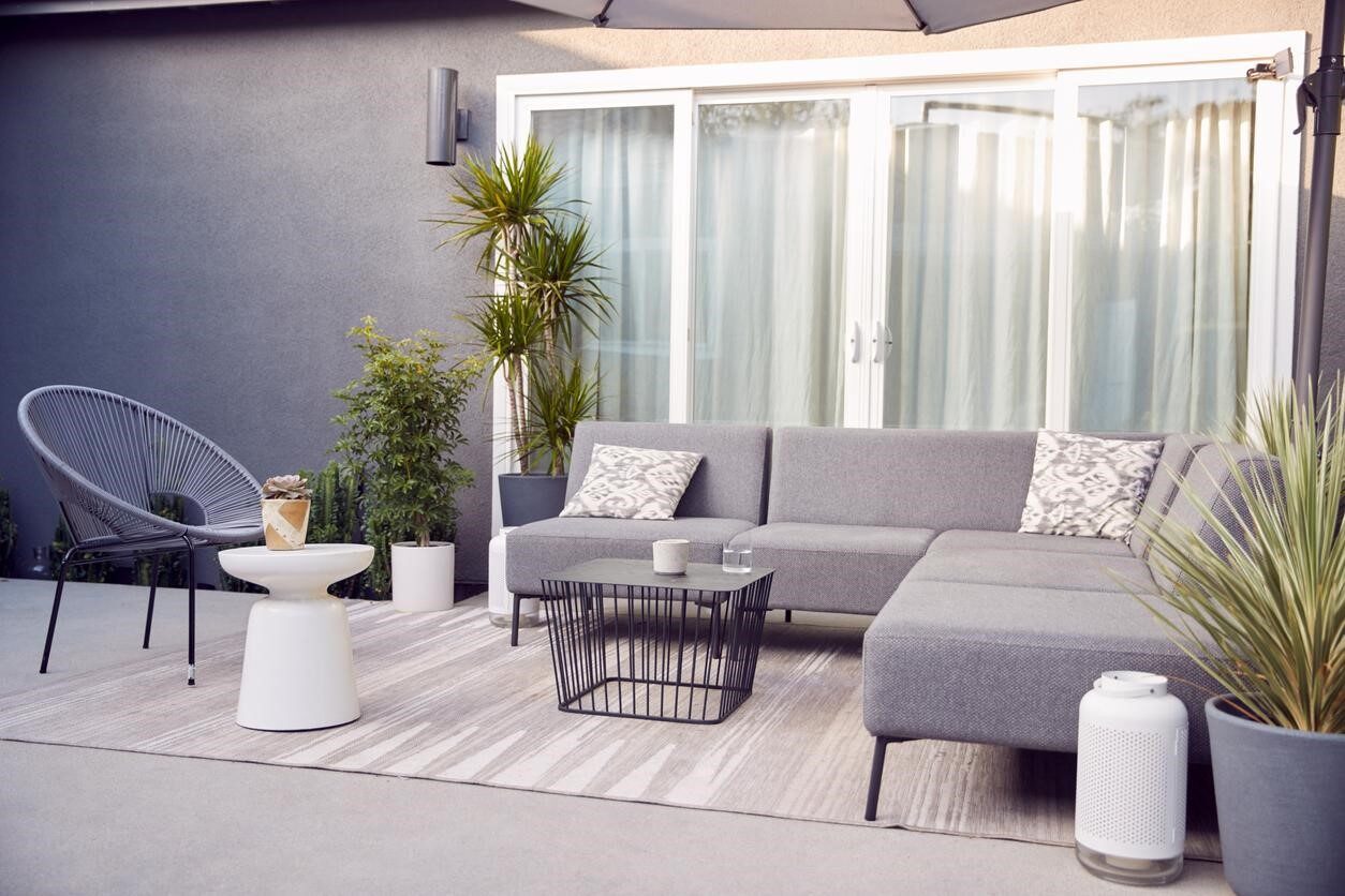 Outdoor seating with garden furniture and patio doors in a contemporary home.