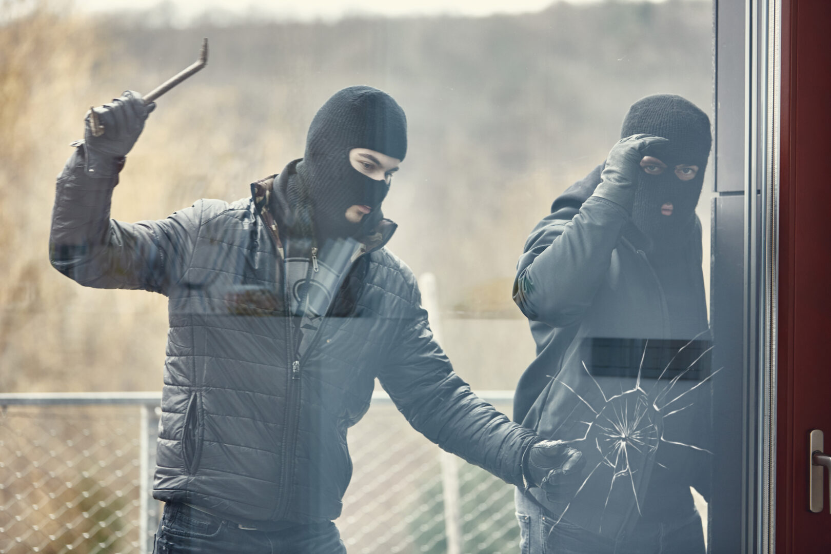 Intruders breaking a glass door